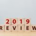 2019 review concept. The word REVIEW on wooden cube block on wood table