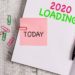 Handwriting text 2020 Loading. Conceptual photo Advertising the upcoming year Forecasting the future event Thick pages notebook stationary placed above classic look wooden backdrop