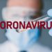 Coronavirus Researcher holds test tube with coronavirus virus, analysis and medicine to fight the epidemic.