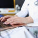 Doctor's hands on laptop keyboard. Remote medical assistance concept