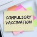 Compulsory vaccination against coronavirus vaccine hesitancy corona virus COVID-19 Covid computer note paper desk