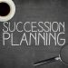 Succession planning concept on blackboard with pen